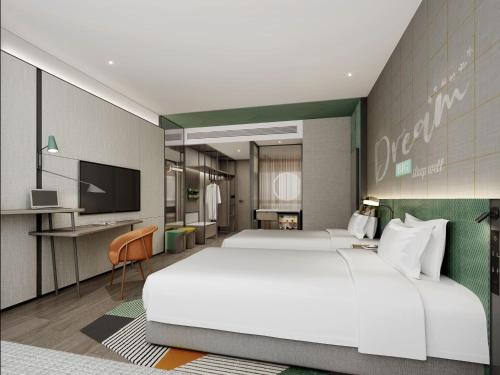 Ein Bett oder Betten in einem Zimmer der Unterkunft EVEN Hotels Shenzhen Guangming Cloud Park by IHG
