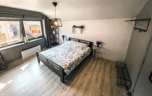 a bedroom with a bed and a window at Le petit Broux in Aywaille