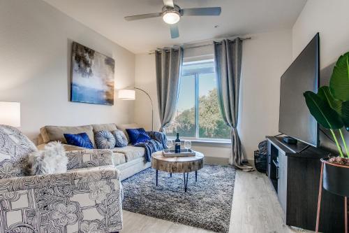 a living room with a couch and a table at Luxury Condo facing RiverWalk Free Parking Pet Friendly Centrally Located in San Antonio