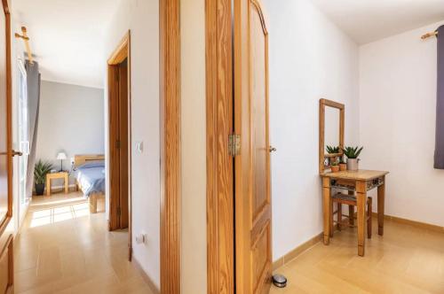 a hallway with a room with a bed and a mirror at Villa Jordi - Cala en Porter in Cala'n Porter