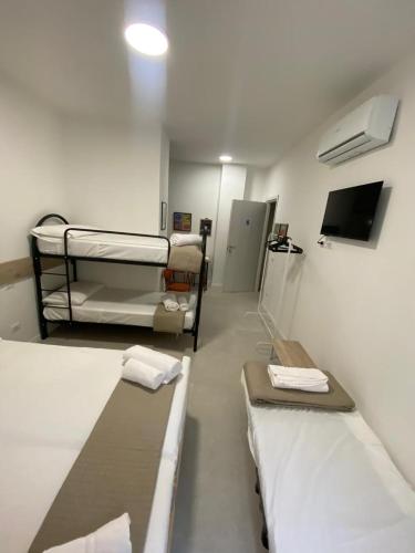 a hospital room with two bunk beds and a tv at San Dionigi 11 Studio Apartments in Milan