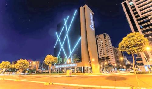 a building with lights on top of it at night at CULLINAN DELUXE in Brasília