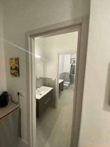 a view of a bathroom with a mirror and a sink at San Dionigi 11 Studio Apartments in Milan