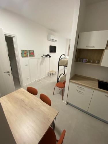 a kitchen with a table and chairs in a room at San Dionigi 11 Studio Apartments in Milan