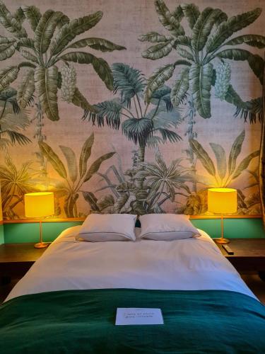 a bedroom with a bed with a wall with palm trees at Lyon Faubourg - Saint Priest in Saint-Priest