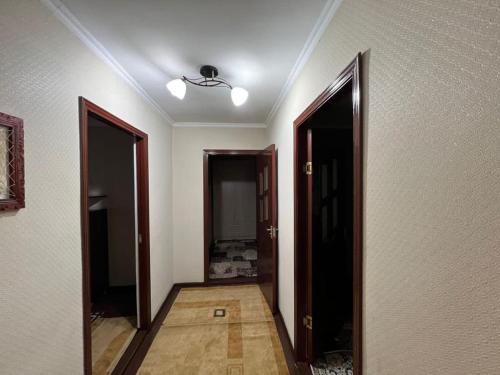 an empty hallway with two doors and a ceiling at Halal Apartment in Osh