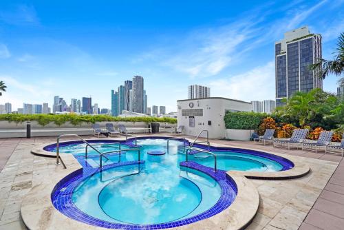 a swimming pool on the roof of a building with a city at Aqua Marina! Water & City Views! in Miami