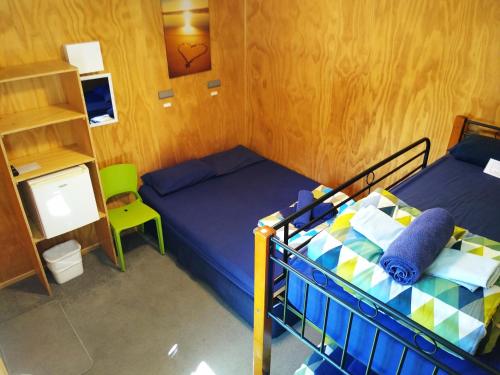 a bedroom with two bunk beds and a desk at Hampshire Holiday Parks - Wanaka in Wanaka