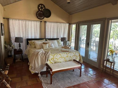 a bedroom with a bed and a clock on the wall at Around the Bend Bungalow in Fredericksburg