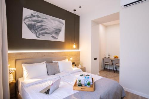 a bedroom with a bed with a tray of drinks on it at hotelise l illusion Apartment in Yerevan