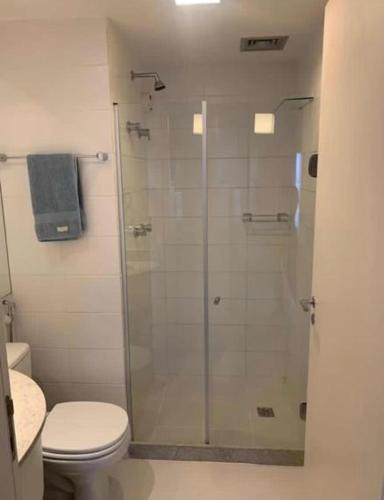a bathroom with a glass shower with a toilet at FLATS VISION in Brasilia