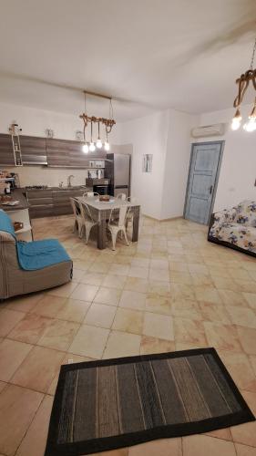 a large living room with a table and a couch at Casa BiBa in Villasimius