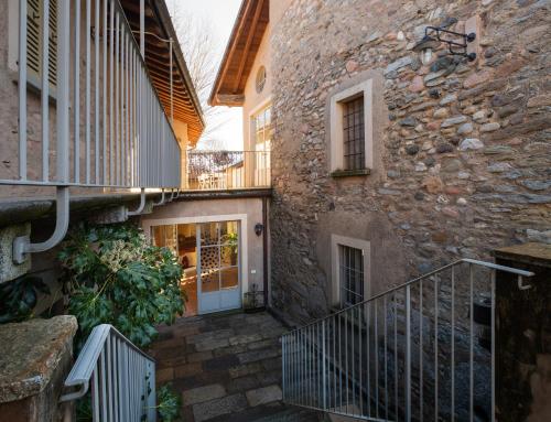 a stone building with a staircase next to a door at Locanda Cà dei Santi in Induno Olona