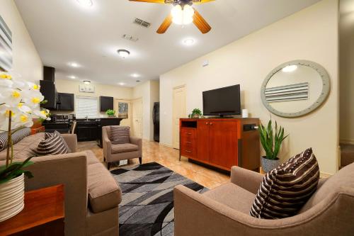 a living room with furniture and a flat screen tv at Hummingbird Haven 2 Cozy Comfort Haven - Parking at No Extra Cost in Pharr