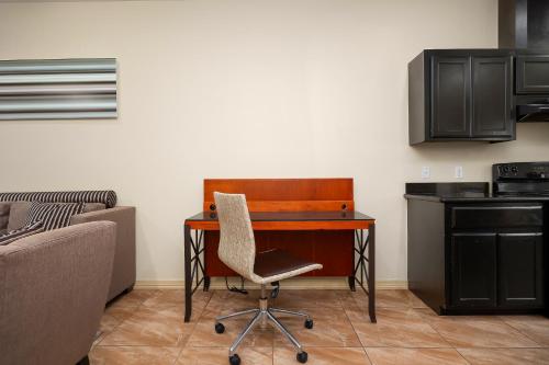 a desk with a chair next to a kitchen at Hummingbird Haven 2 Cozy Comfort Haven - Parking at No Extra Cost in Pharr