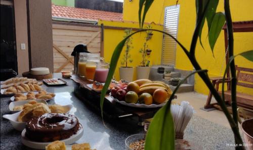 a table with a bunch of different types of food at Pousada Filhos da Canastra in Vargem Bonita