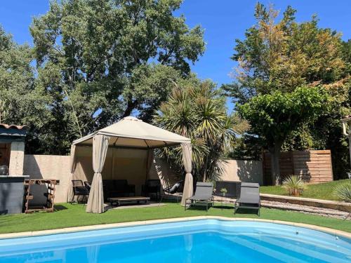 a gazebo and chairs next to a swimming pool at Cocon Classé 3 Etoiles - Love et Détente - SPA in Carpentras