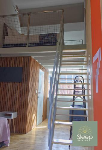a staircase in a room with a bunk bed at Sleep Hotel in Worthing
