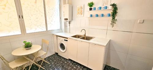 a kitchen with a sink and a washing machine at Your home in Valencia in Valencia