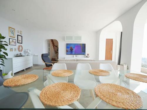 a living room with a glass table and chairs at A+View Private Terrace Private Pool Family Fun in Badalona