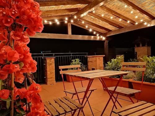 a patio with a table and chairs and lights at CASA LITA con terrazzo in Ravenna