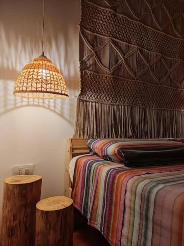 a bedroom with a bed with a colorful blanket and a lamp at CASA LITA con terrazzo in Ravenna