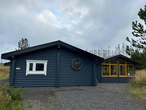 a blue house with a window on the side of it at Luxury cottage located in the Golden Circle, mountain view! in Laugarvatn