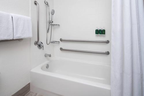 a white bathroom with a tub and a shower at SpringHill Suites Scottsdale North in Scottsdale