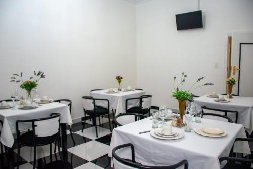 a room with tables and chairs with white table cloth at Ditoro Boutique Hotel in Pretoria