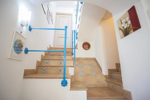a spiral staircase with blue railings in a home at B&B Celestina Ischia in Ischia