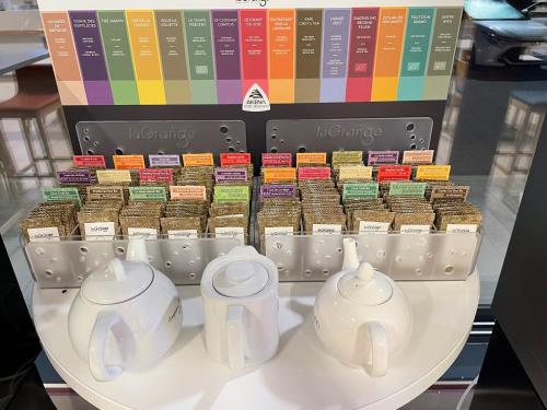 a display of tea pots and tea cups on a table at Hôtel AKENA Besançon in Besançon