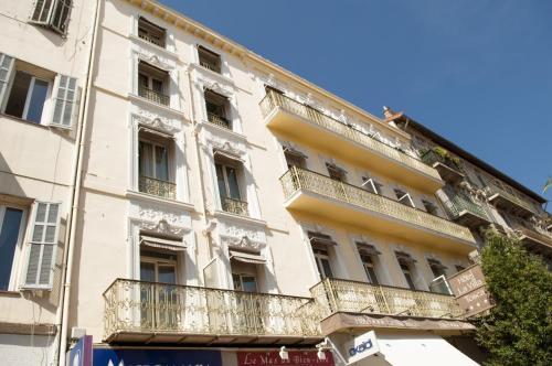 an apartment building with balconies on a street at Hôtel La Villa Tosca in Cannes