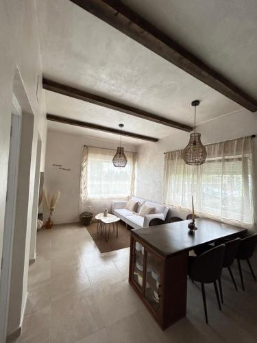 a living room with a white couch and a table at El Rincón de Manuela in Sarria