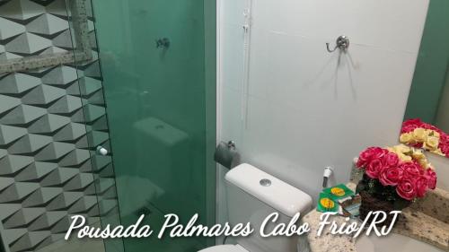 a bathroom with a shower and a sink with a mirror at Pousada Palmares in Cabo Frio
