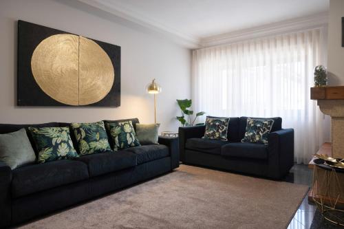a living room with a couch and a table at Home Essences in Porto
