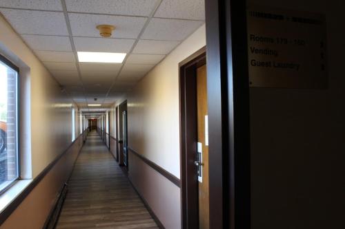 a hallway in an office building with a long corridor at Bellevue Hotel and Suites in Bellevue