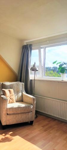 a living room with a couch and a window at Zeelui in Egmond aan Zee