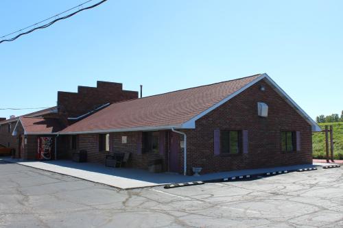 a large brick building with a driveway in front of it at Bellevue Hotel and Suites in Bellevue