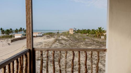 a view of the beach from a balcony at Casa da Duna in Tatajuba