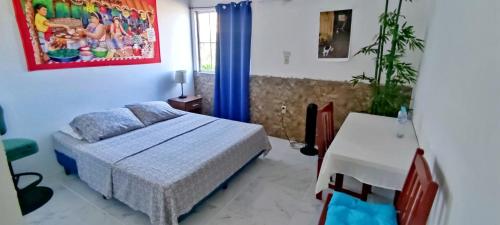 a bedroom with a bed and a table in it at Playa El Obispo D La Marea building La Libertad in La Libertad