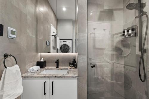 a bathroom with a shower and a sink at North Adelaide Boutique Stays Accommodation in Adelaide