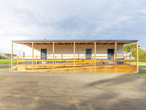 a large white building with a large porch at NRMA Portland Bay Holiday Park in Portland
