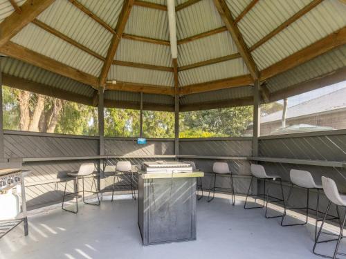 a large metal pavilion with chairs and a table at NRMA Portland Bay Holiday Park in Portland