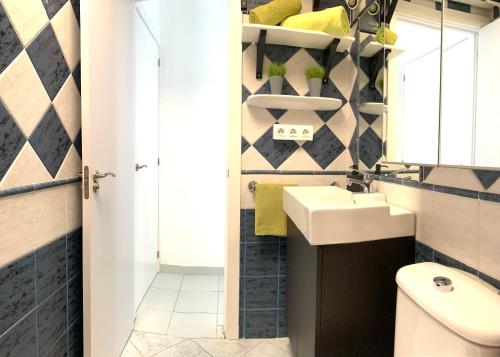 a bathroom with a sink and a toilet at Bungalow Helena in Maspalomas