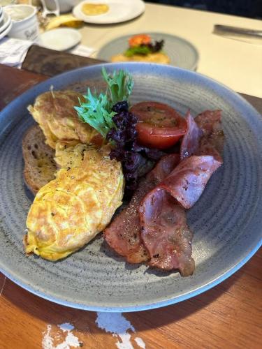 a plate of breakfast food with eggs bacon and toast at Nusa Indah Bungalow in Nusa Lembongan
