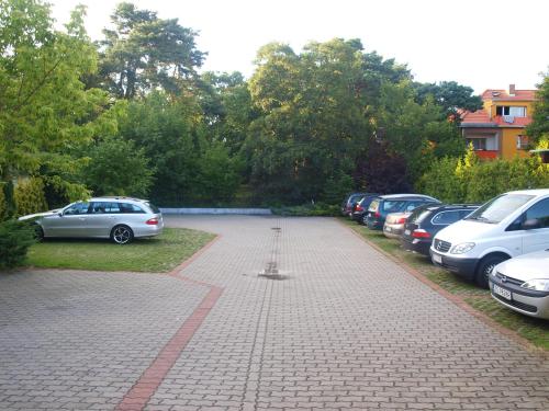 a parking lot with a bunch of cars parked at Villa Jedynak in Świnoujście