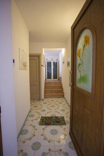 a hallway with a door and a tile floor at B&B Celestina Ischia in Ischia