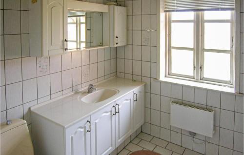 ein weißes Bad mit einem Waschbecken und einem WC in der Unterkunft Frgegaard in Arup