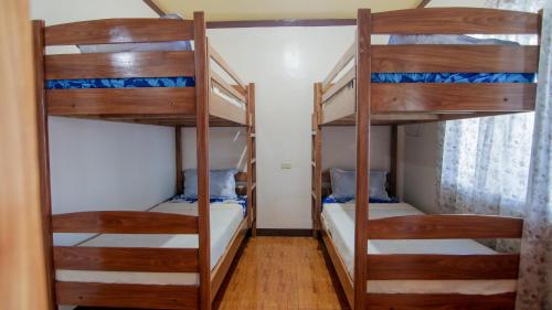 a bedroom with two bunk beds in a room at Gratum Beach Resort in Dapitan