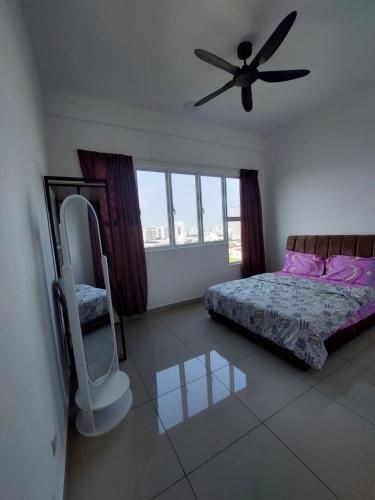 a bedroom with a bed and a ceiling fan at Amber cove in Malacca